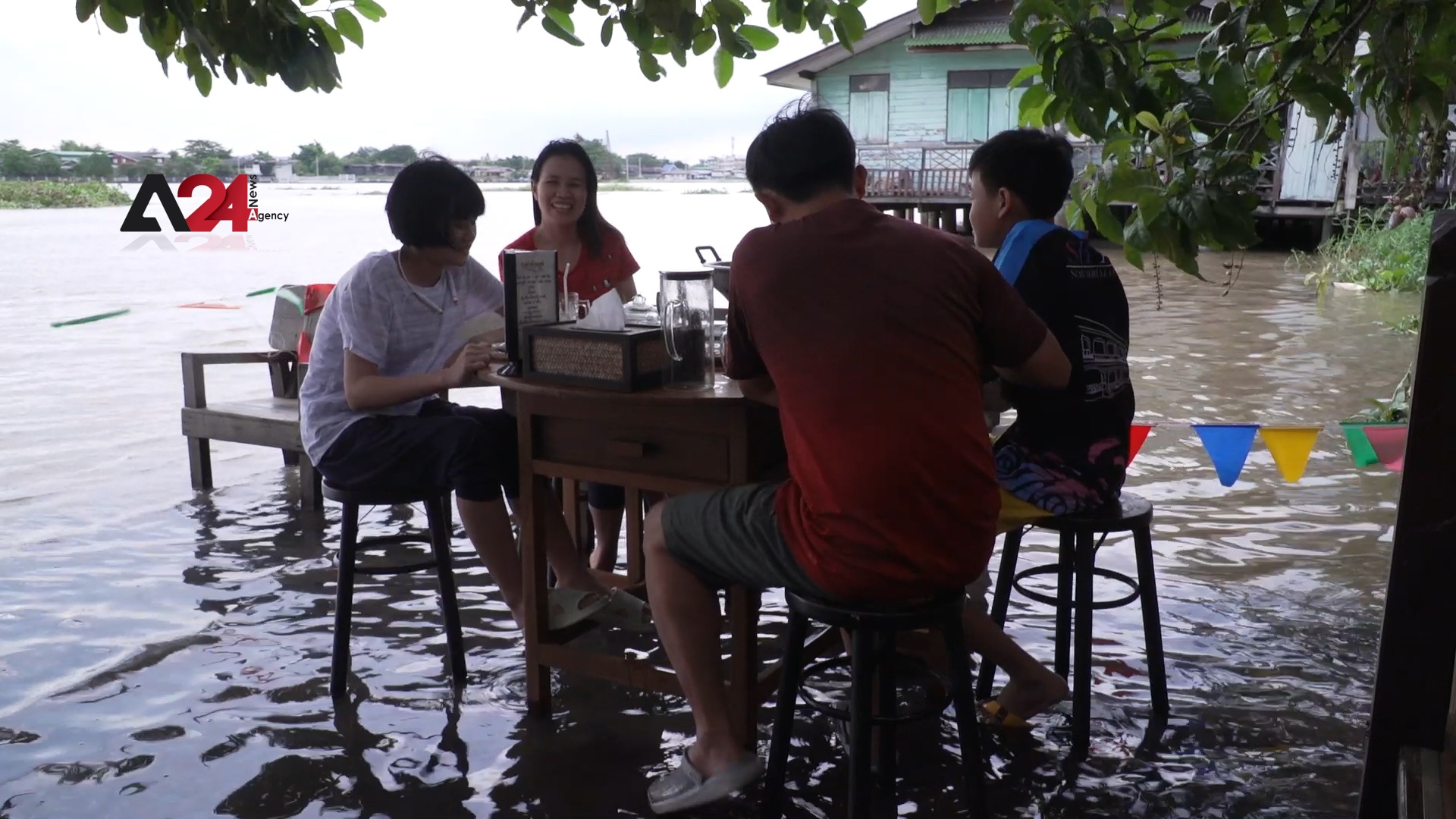 Thailand - Riverbank restaurant takes advantage of the annual flood to attract customers
